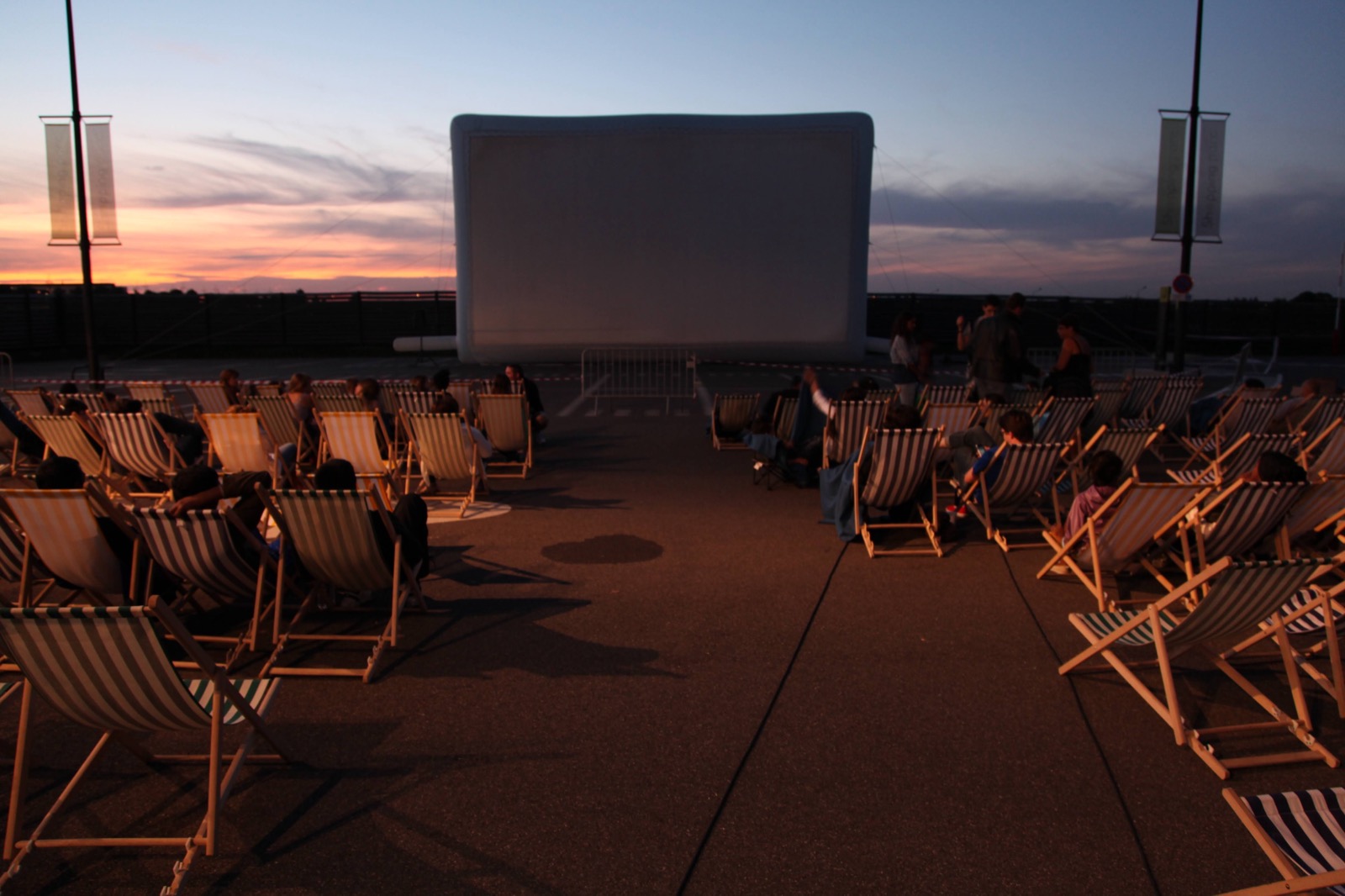 A fully organised open-air cinema screening: an inflatable Hallucine screen, deckchairs and an audience