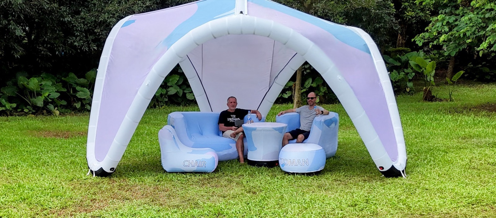 An 'Hallucine' inflatable tent and inflatable furniture set up outdoors on a lawn